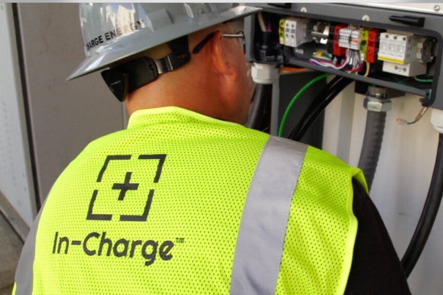 A person in a safety vest and hardhat