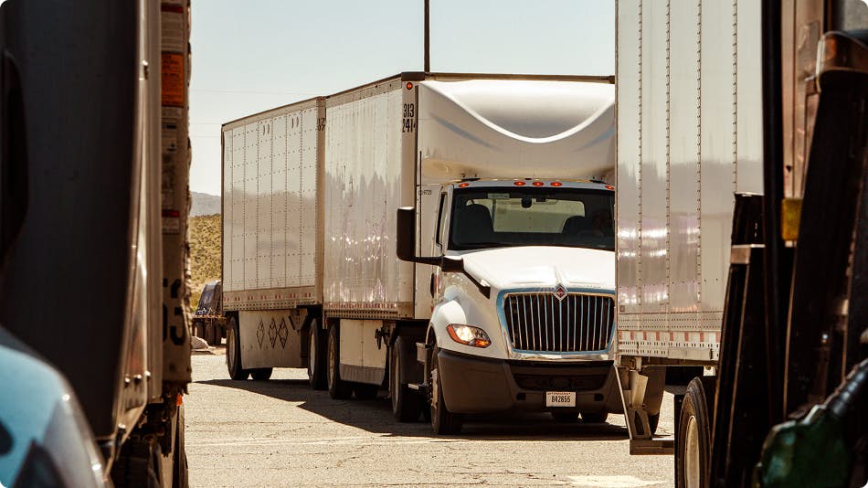 A truck parked behind another truck