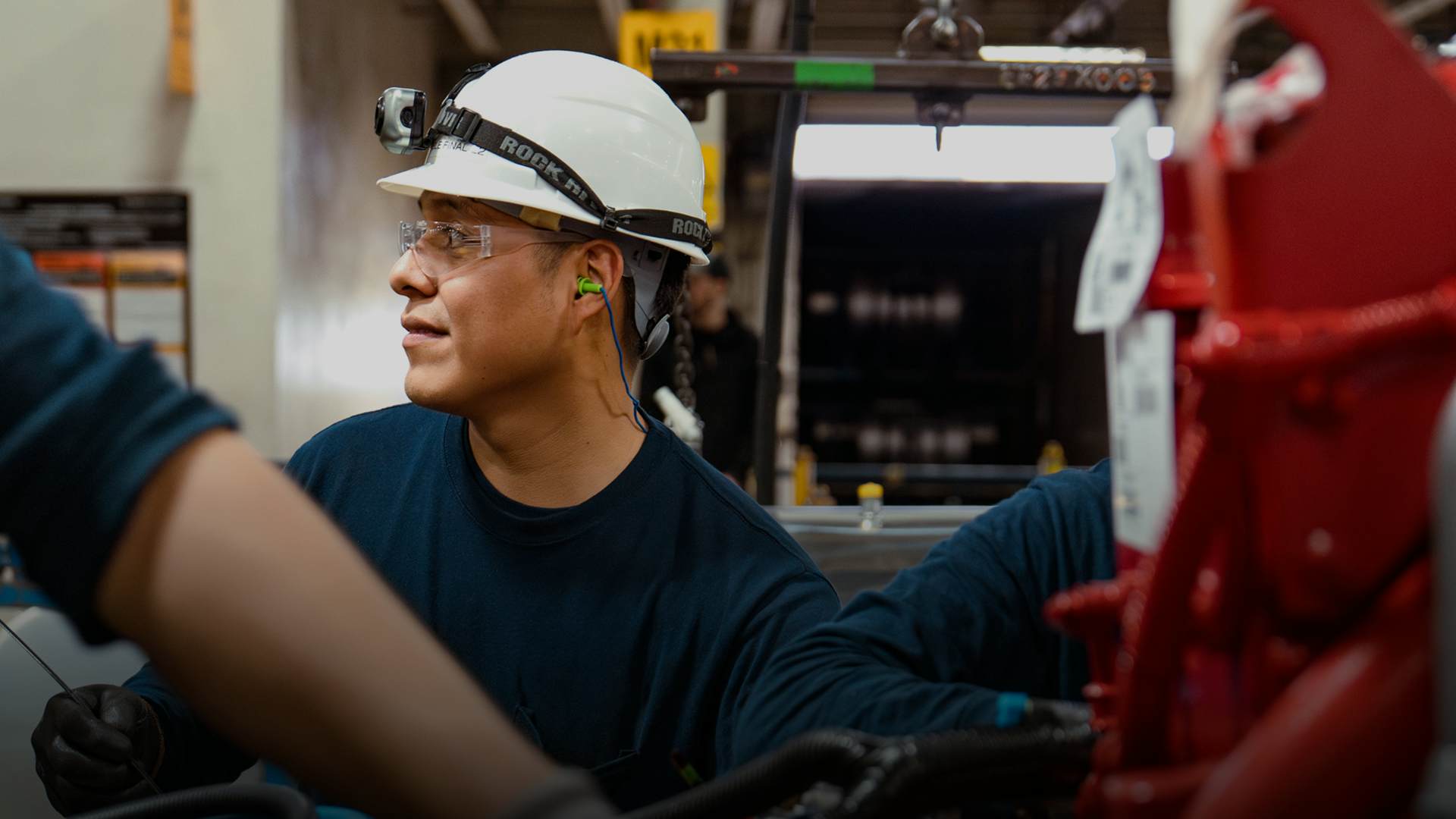 A person wearing a construction hat