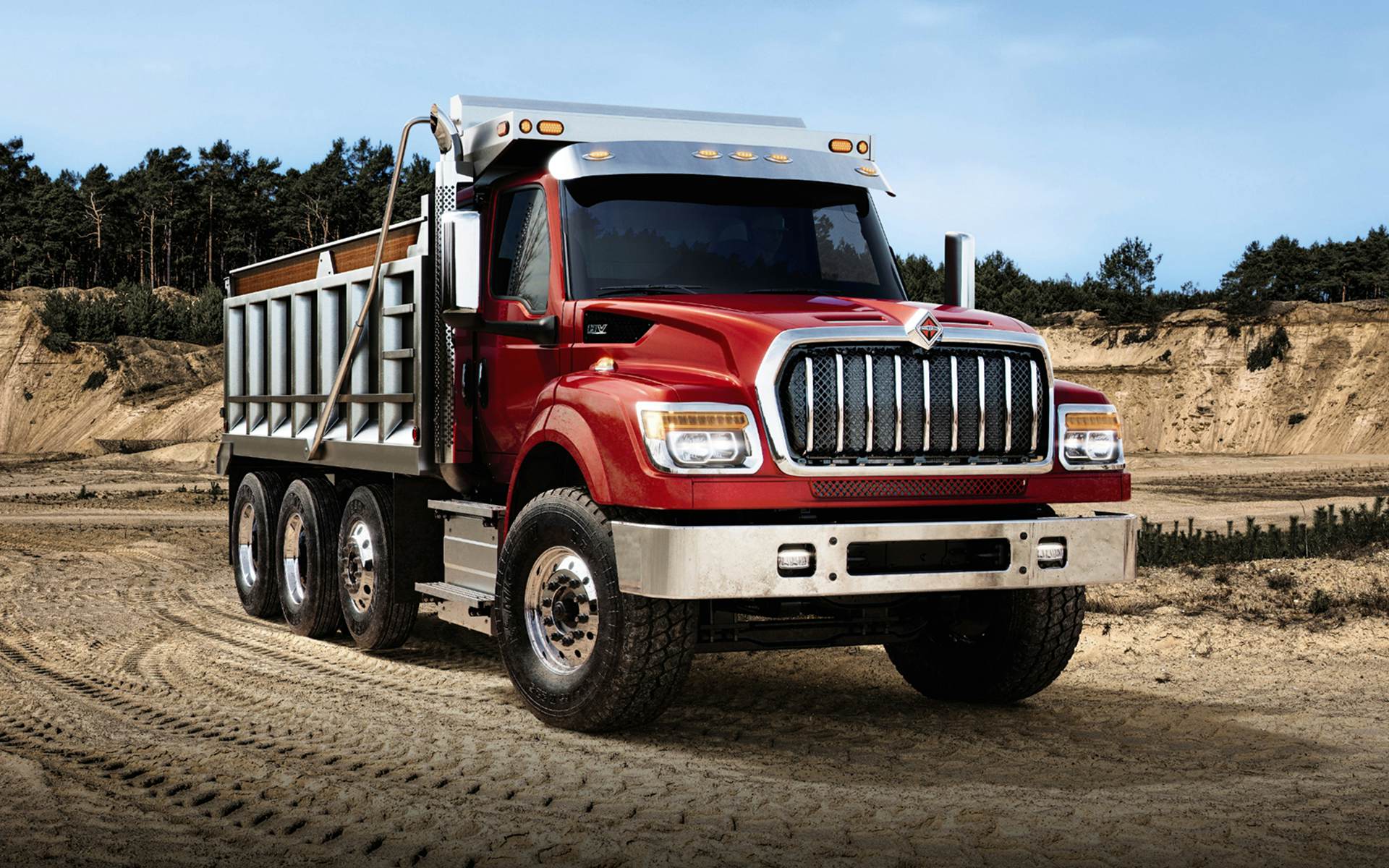 A red truck on a dirt road