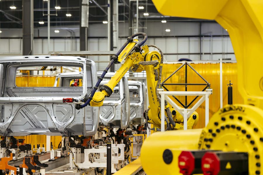 A yellow robot arm in a factory