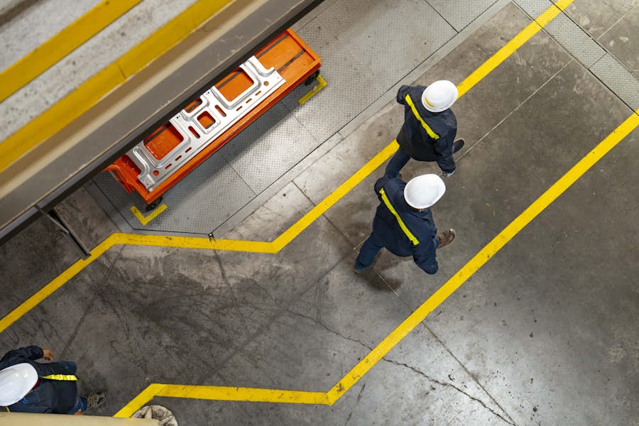 Bird's-eye view of employees walking in a plant.