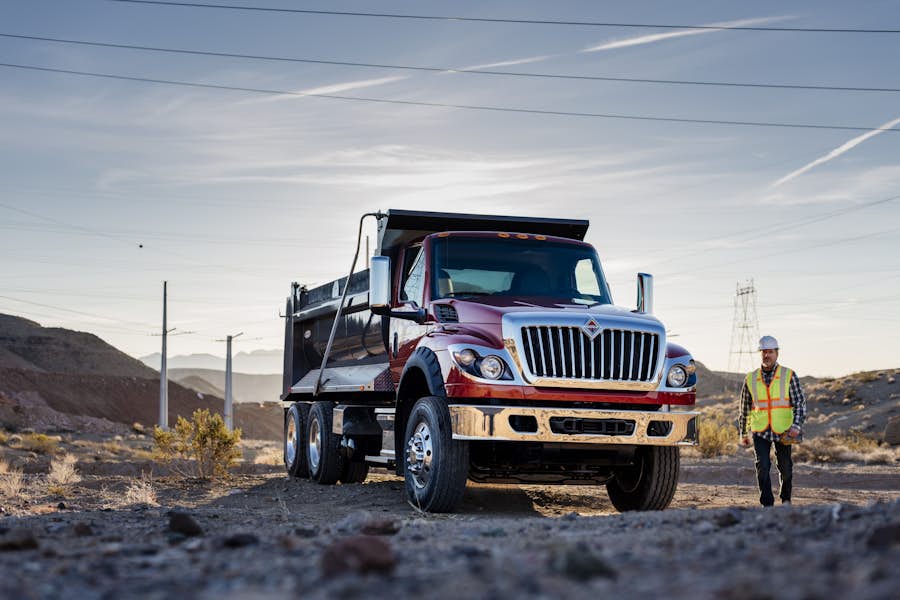 A red and silver truck on a dirt road