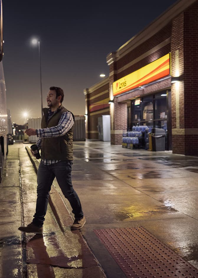 A person standing next to a semi truck