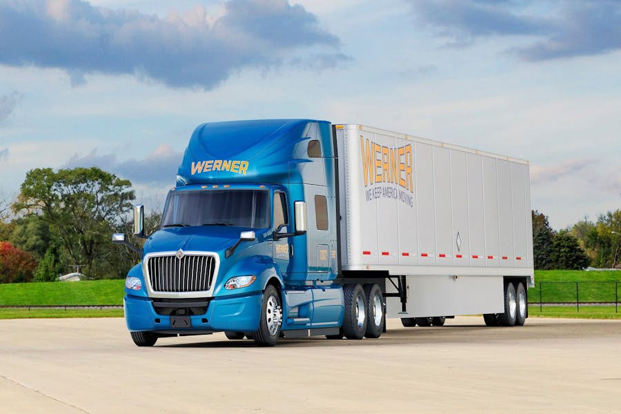 A blue semi truck on a road